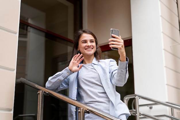 Donna a tiro medio con smartphone