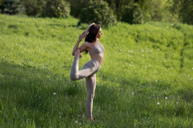 Donna a tutto campo che fa yoga all'aperto