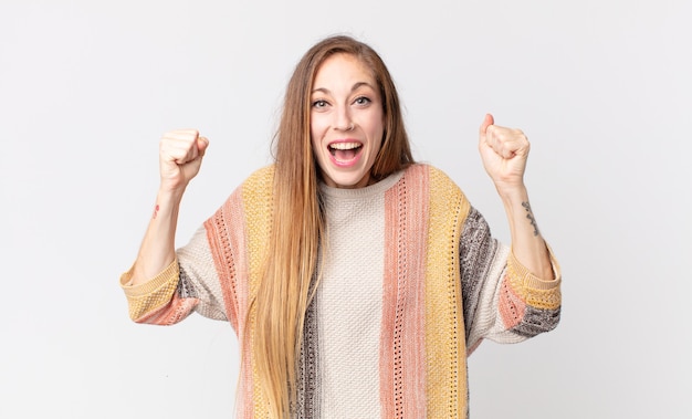 Donna abbastanza magra che si sente felice, positiva e di successo, celebrando la vittoria, i risultati o la buona fortuna