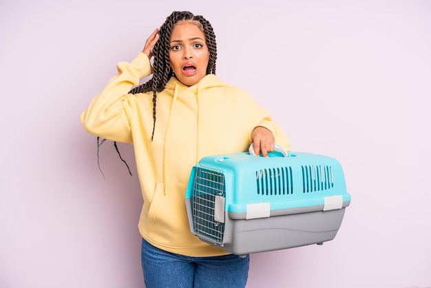 Donna afro nera che urla con le mani in alto. concetto di contenitore da viaggio per animali domestici