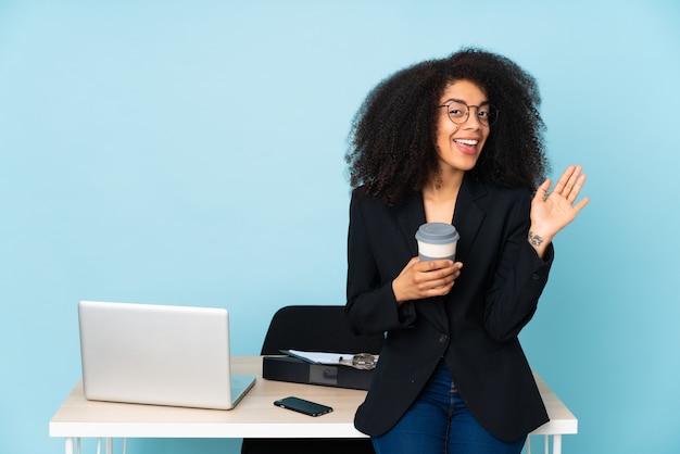 Donna afroamericana di affari che lavora nel suo posto di lavoro