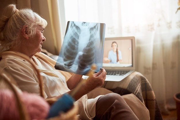 Donna anziana che ha una consultazione online con il medico a casa