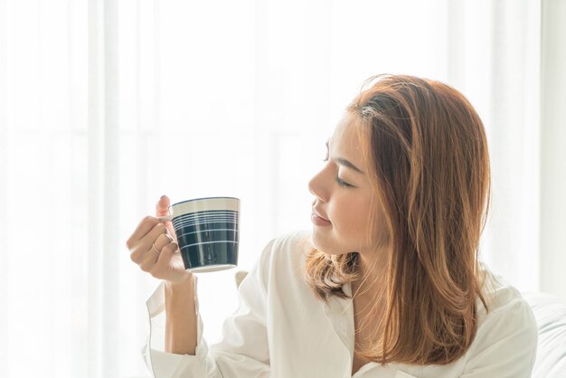 Donna asiatica che beve caffè