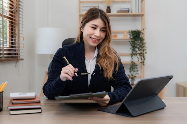 Donna asiatica che lavora con il computer portatile a casa lavora dal concetto di casa