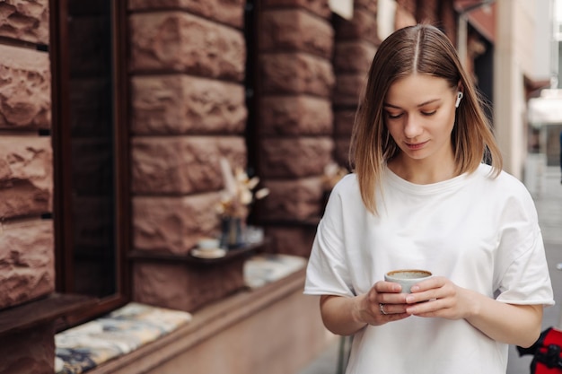 Donna caucasica che usa il suo smartphone per strada