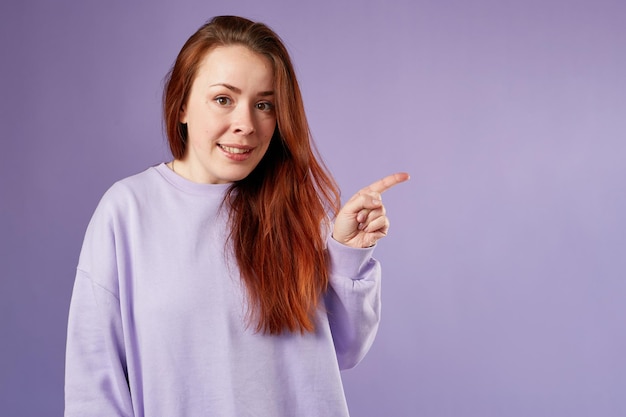 Donna caucasica in felpa viola Aspetto naturale Sorridente capelli lunghi rossi Sfondo bianco