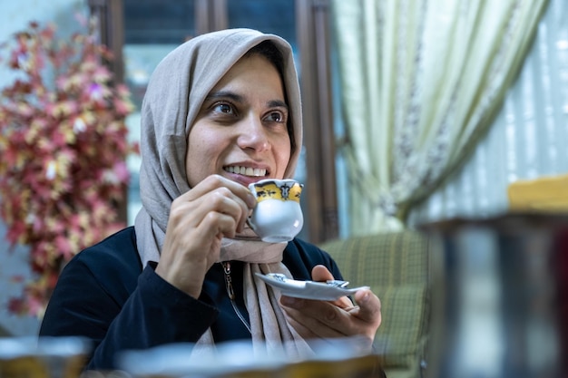 Donna che beve caffè con faccina sorridente