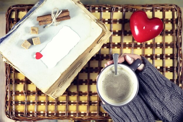 Donna che beve caffè e guarda il biglietto di San Valentino