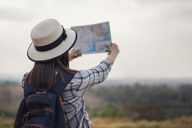 Donna che cerca la direzione sulla mappa durante il viaggio