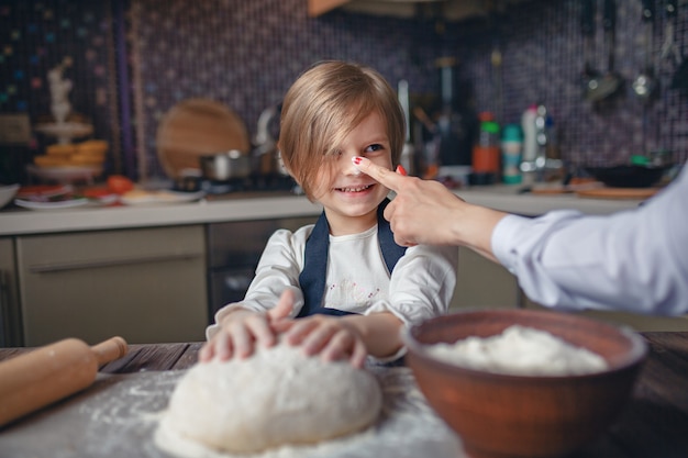 Donna che cucina e si diverte con la bambina