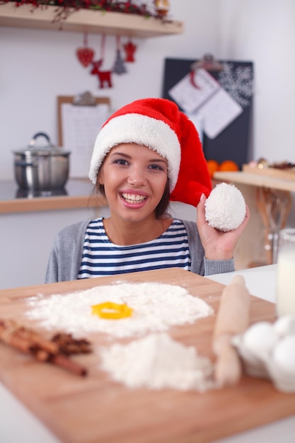 Donna che fa i biscotti di natale in cucina