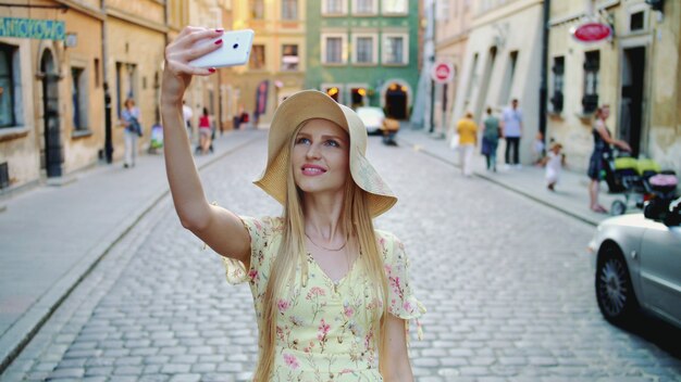 Donna che fa un giro turistico e che fa i colpi. Ragazza allegra che fa un giro turistico e che prende i colpi sulla vecchia via della città.