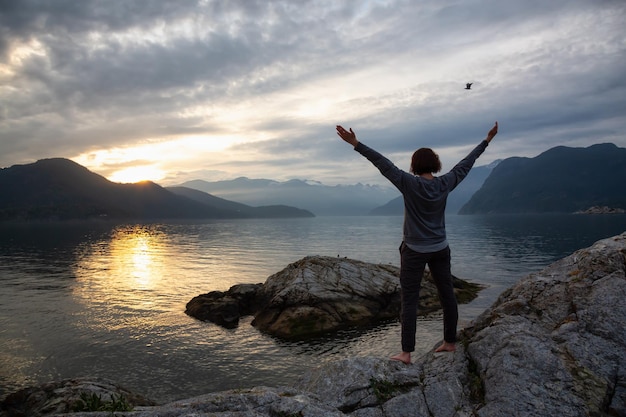 Donna che gode del paesaggio montano canadese durante un tramonto vibrante