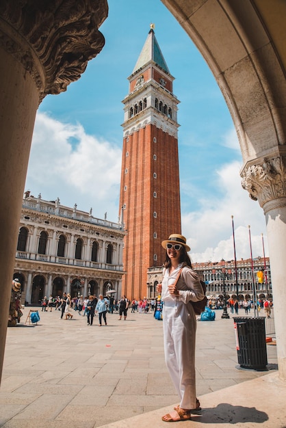 Donna che guarda il campanile della città di venezia estate folla di turisti