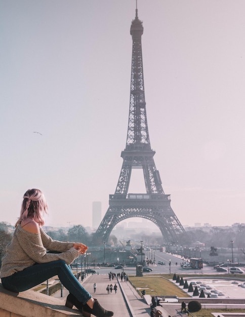 Donna che guarda la Torre Eiffel contro il cielo