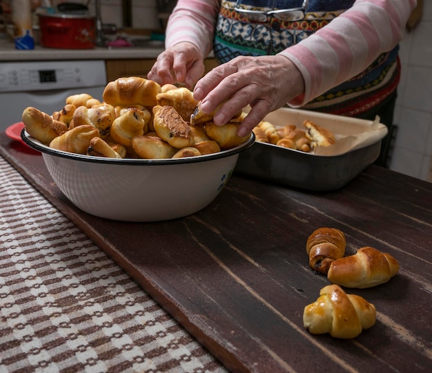 Donna che produce panini fatti in casa con marmellata a casa