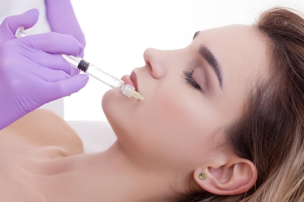 Donna che riceve un'iniezione di botox nelle sue labbra close upxA