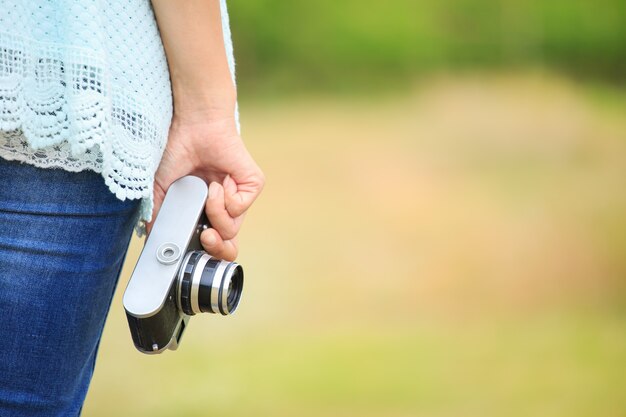 Donna che tiene la macchina fotografica intage vecchio stile in modo semplice