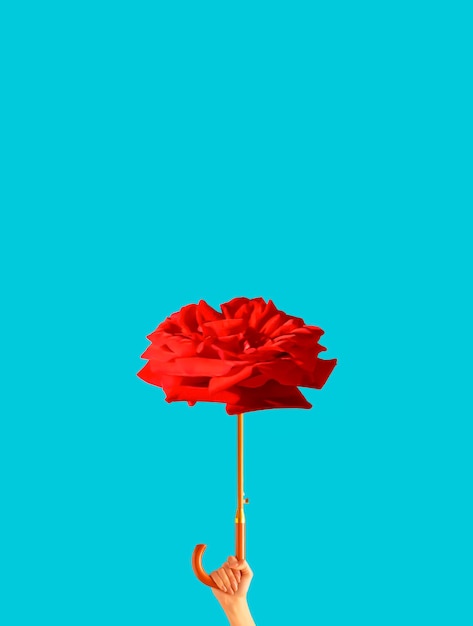 Donna che tiene ombrello fatto di fiori di rosa rossa su sfondo azzurro San Valentino o 8 marzo concetto