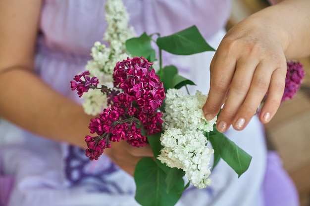 Donna con bouquet di lillak bianco nel suo hahd