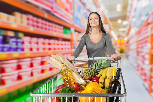 Donna con carrello della spesa al supermercato