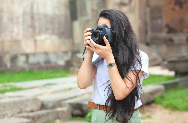 Donna con la macchina fotografica che tiene la mano