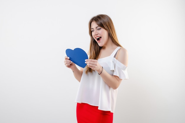 Donna con sorridere blu della carta del biglietto di S. Valentino a forma di cuore isolato