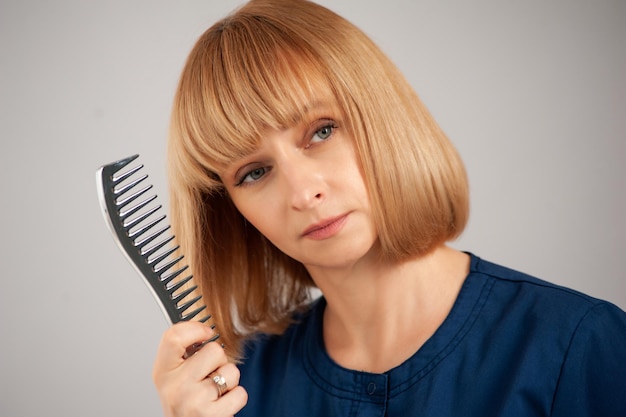 Donna con spazzole per capelli sullo sfondo. Medico