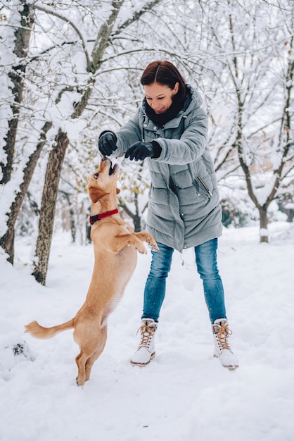 Donna con un cane su una neve