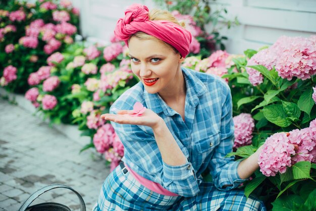 Donna cura dei fiori in giardino cura dei fiori e irrigazione terreni e fertilizzanti fiori in serra ha