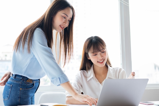 Donna d'affari asiatica e colleghi che discutono di lavorare insieme