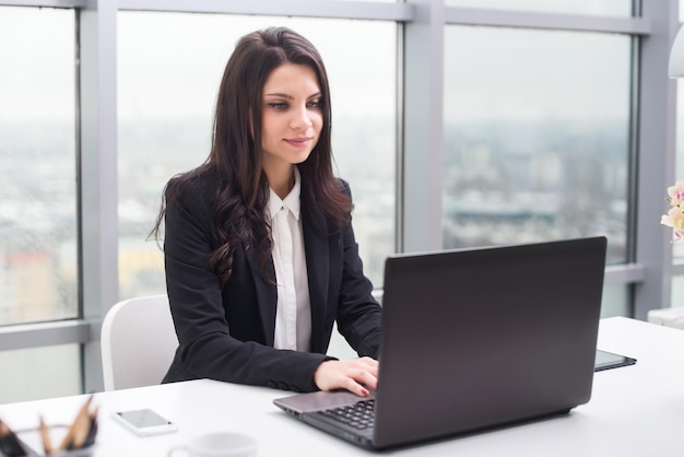 Donna d'affari con il taccuino nel posto di lavoro dell'ufficio