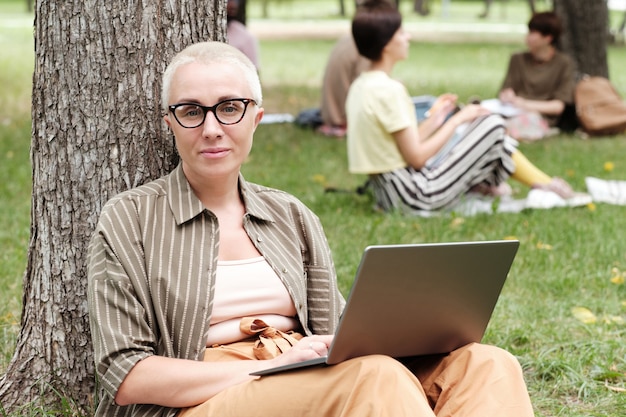 Donna d'affari con laptop seduto all'aperto