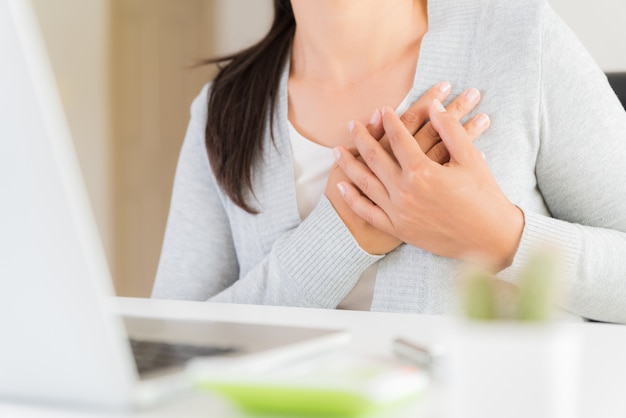 Donna di affari del primo piano che ha attacco di cuore.