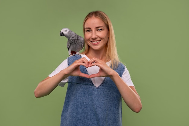 Donna di tiro medio con pappagallo in studio