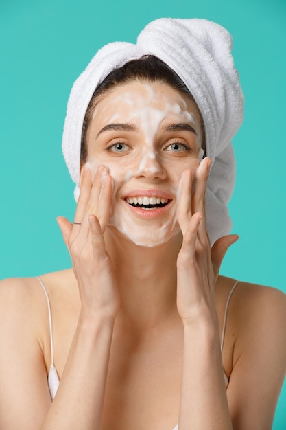Donna di trattamento di bellezza che applica schiuma per la pulizia del viso