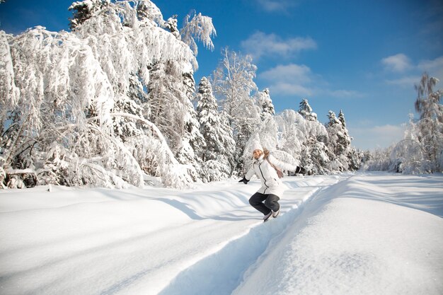 Donna felice nella foresta di inverno nevoso