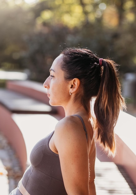 Donna fitness che fa esercizi di yoga che si allungano nel parco estivo Concetto di sport sano