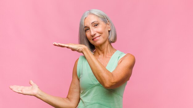 Donna graziosa di mezza età che sorride e che si sente felice