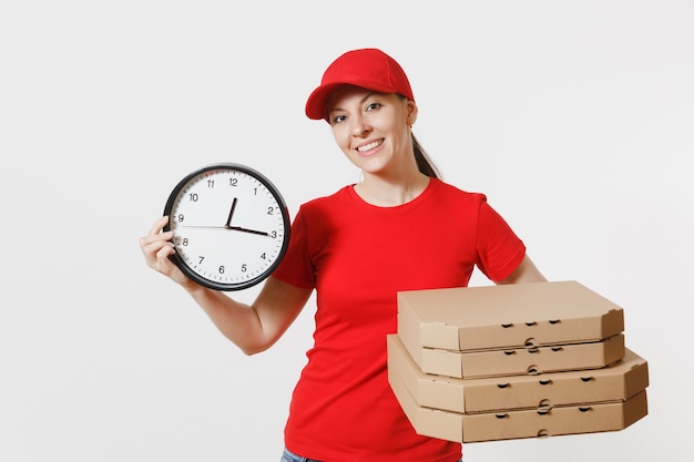 Donna in berretto rosso, t-shirt che dà scatole per pizza ordine cibo isolati su sfondo bianco. Rivenditore di corriere pizzaiolo femminile che tiene orologio rotondo, pizza italiana in flatbox di cartone. Concetto di servizio di consegna.