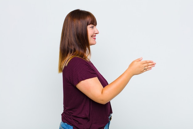 Donna in sovrappeso che sorride, ti saluta e ti offre una stretta di mano per chiudere un affare di successo, concetto di cooperazione