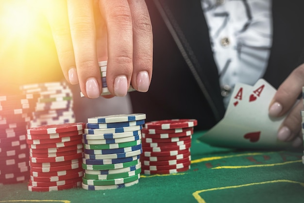 Donna in tuta che gioca a poker con carte e fiches Concetto di gioco