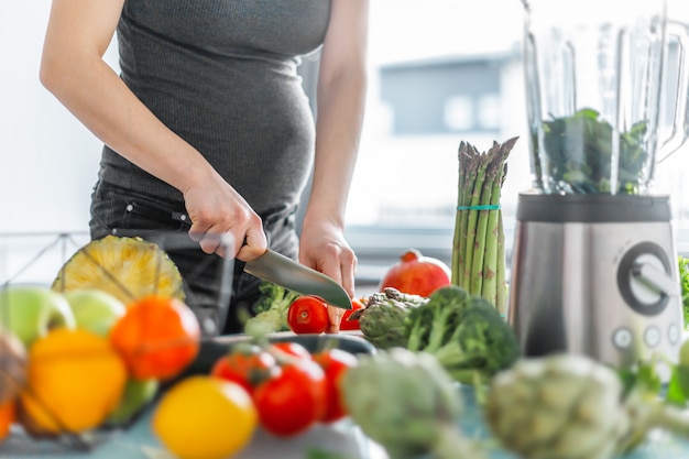 Donna incinta che cucina cibo sano