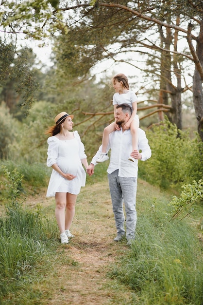 Donna incinta con la sua famiglia che sembra felice