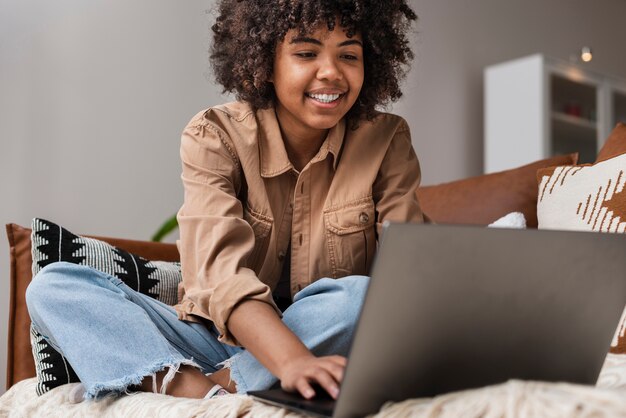 Donna sorridente che osserva sul computer portatile