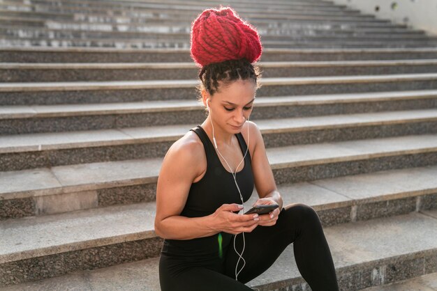 Donna sportiva con smartphone per prestazioni di progresso e comunicazione per uno stile di vita sano