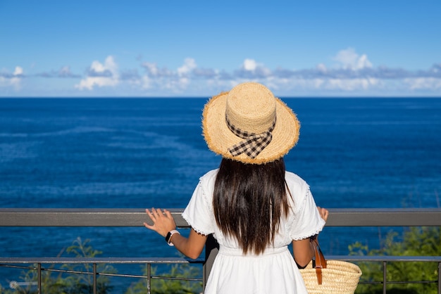 Donna vai a viaggiare con lo sfondo del mare blu