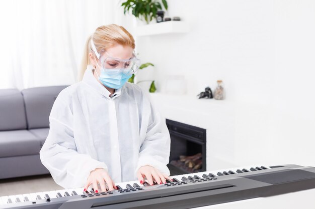 dottoressa con maschera protettiva suona il pianoforte