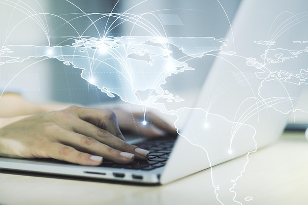 double exposure of abstract digital world map with connections and hand typing on computer keyboard on background big data and blockchain concept