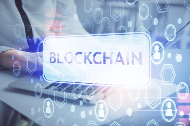 Double exposure of woman hands typing on computer and crypto market theme hologram drawing Blockchain concept